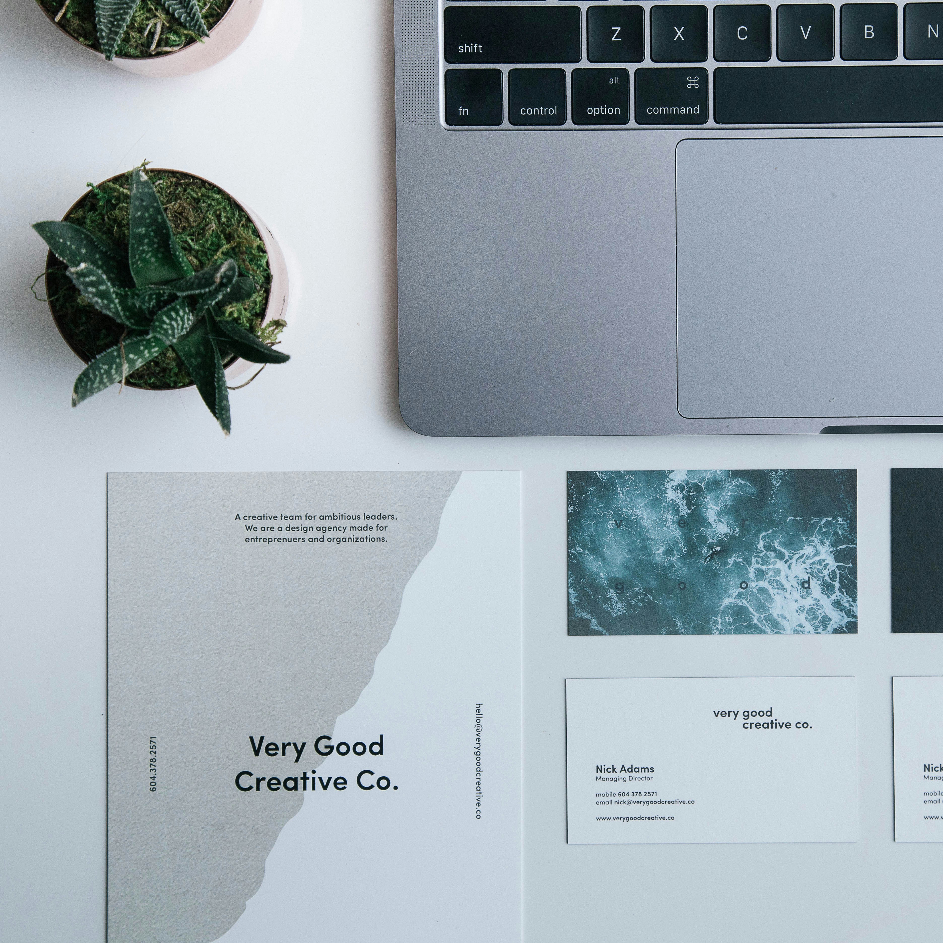 Printed business cards next to Laptop