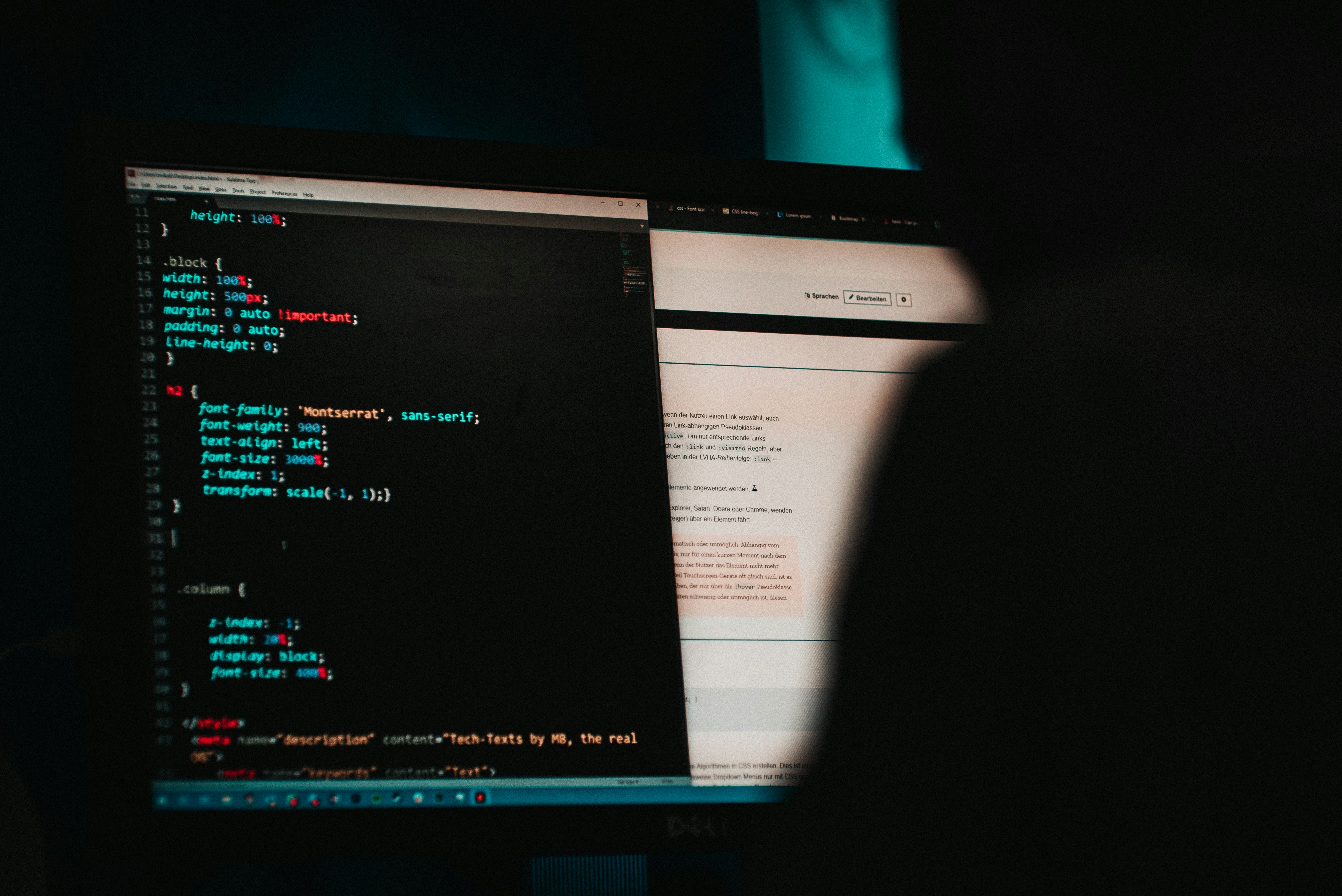 Shadow of a person viewing a websites code on a computer.